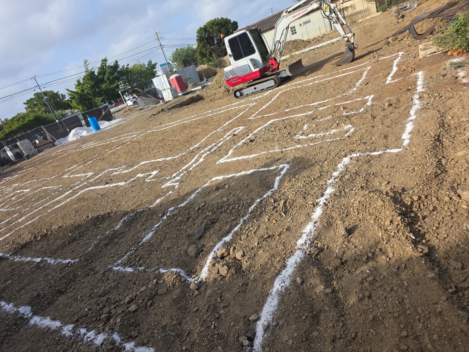 Marked foundation layout with a JDS excavator on site