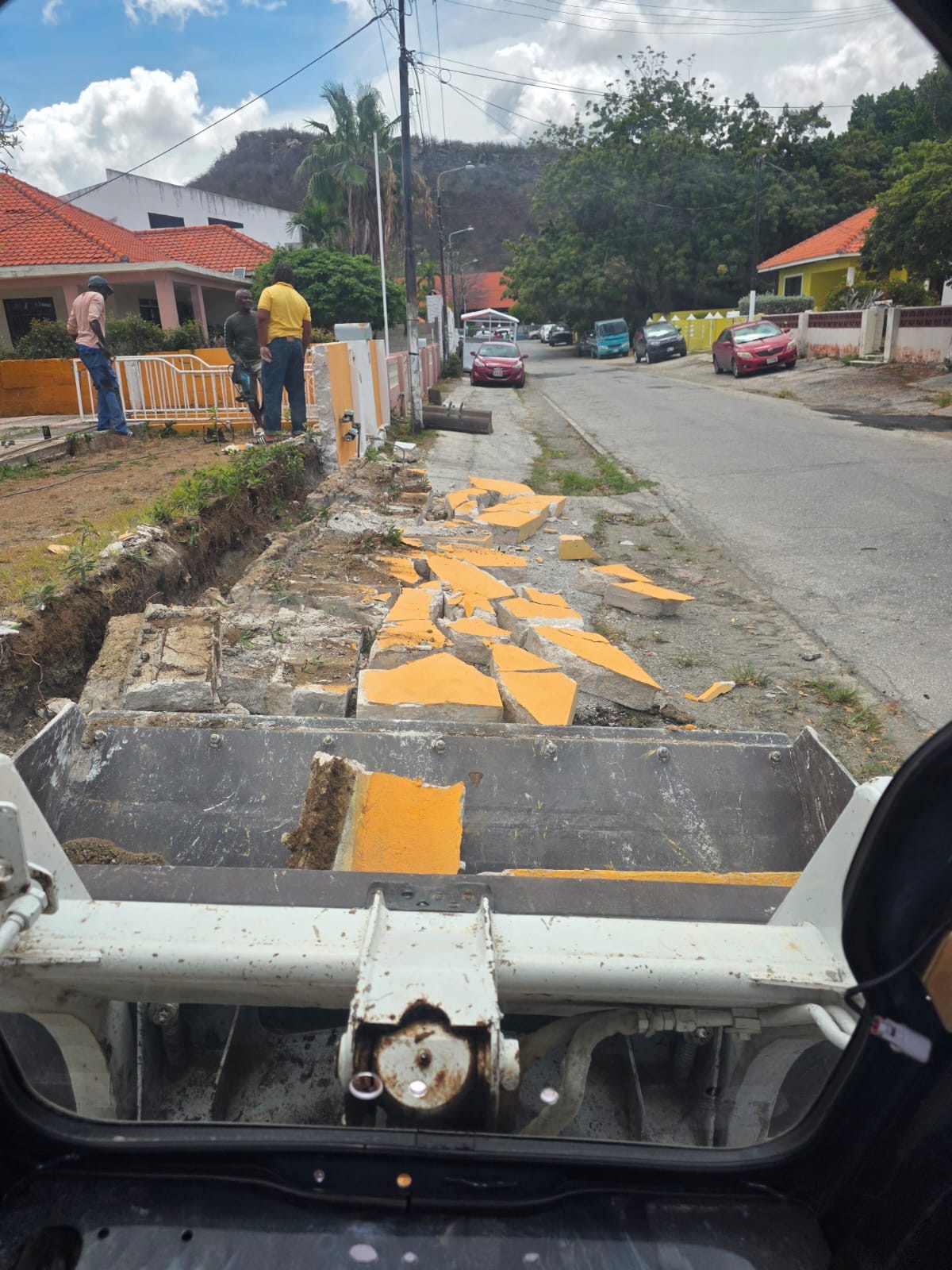 Bobcat clearing broken material from a residential property