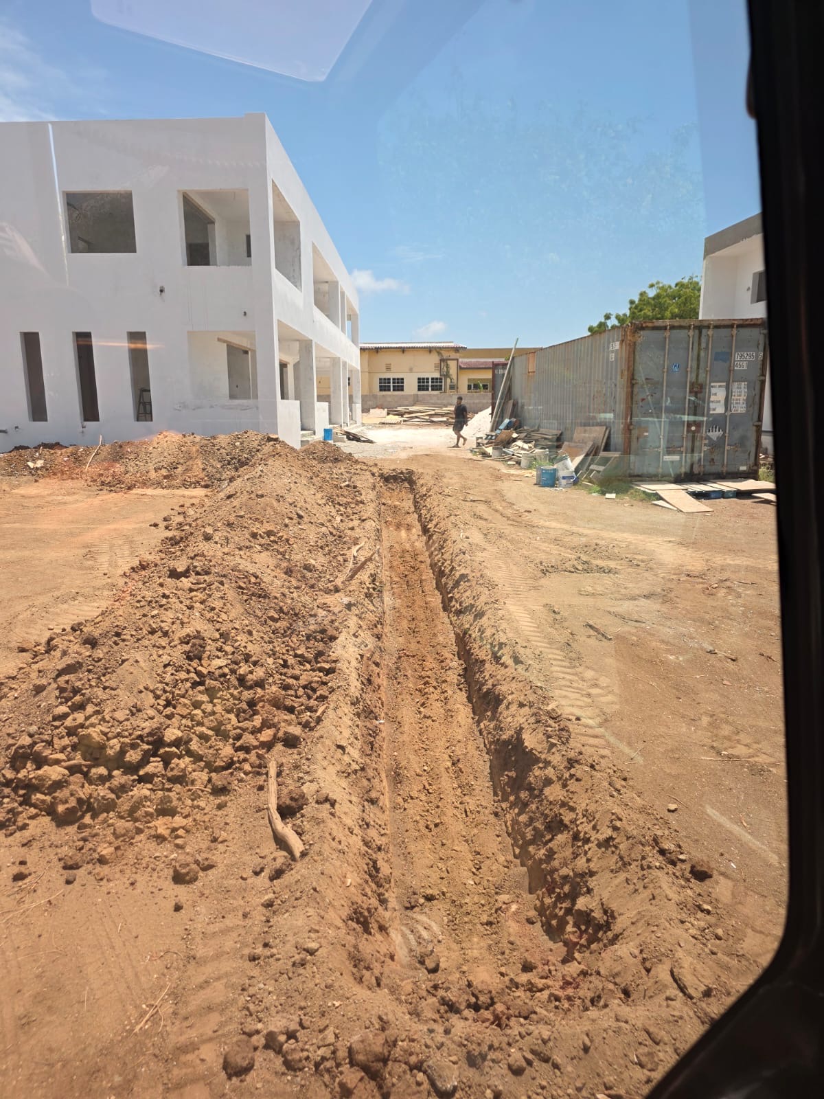 Fresh utility trench excavated beside a building in Curaçao